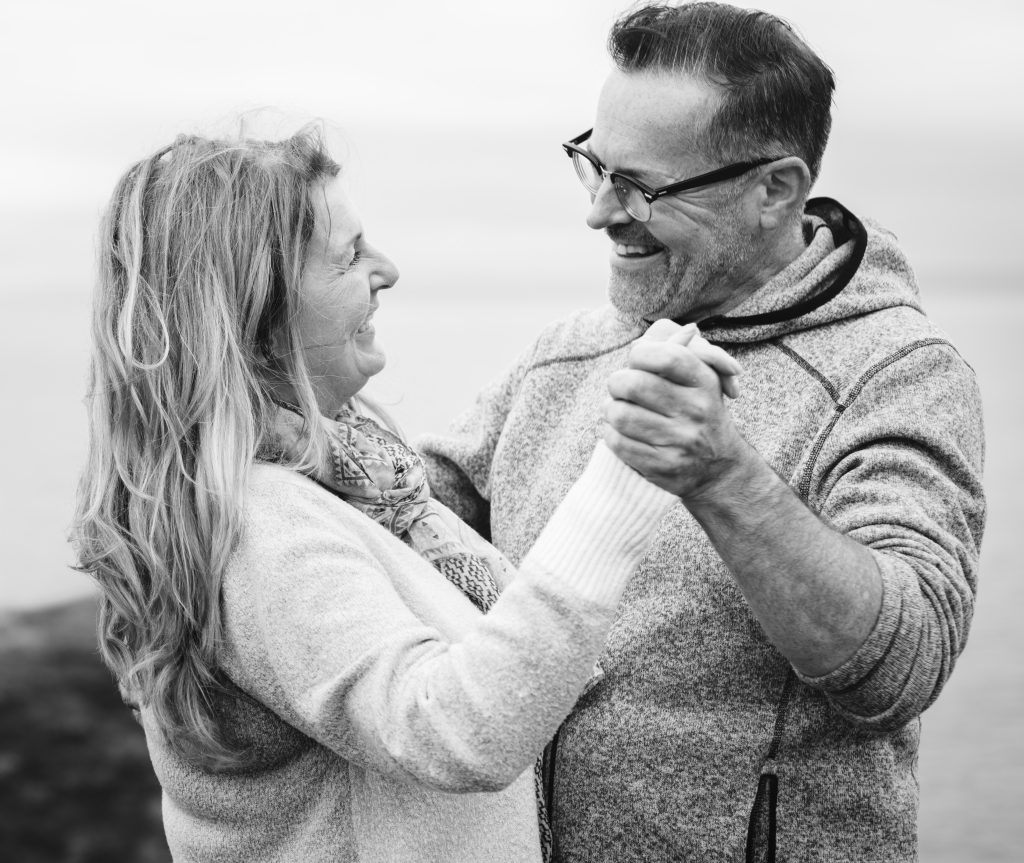 Mature man and woman dance.